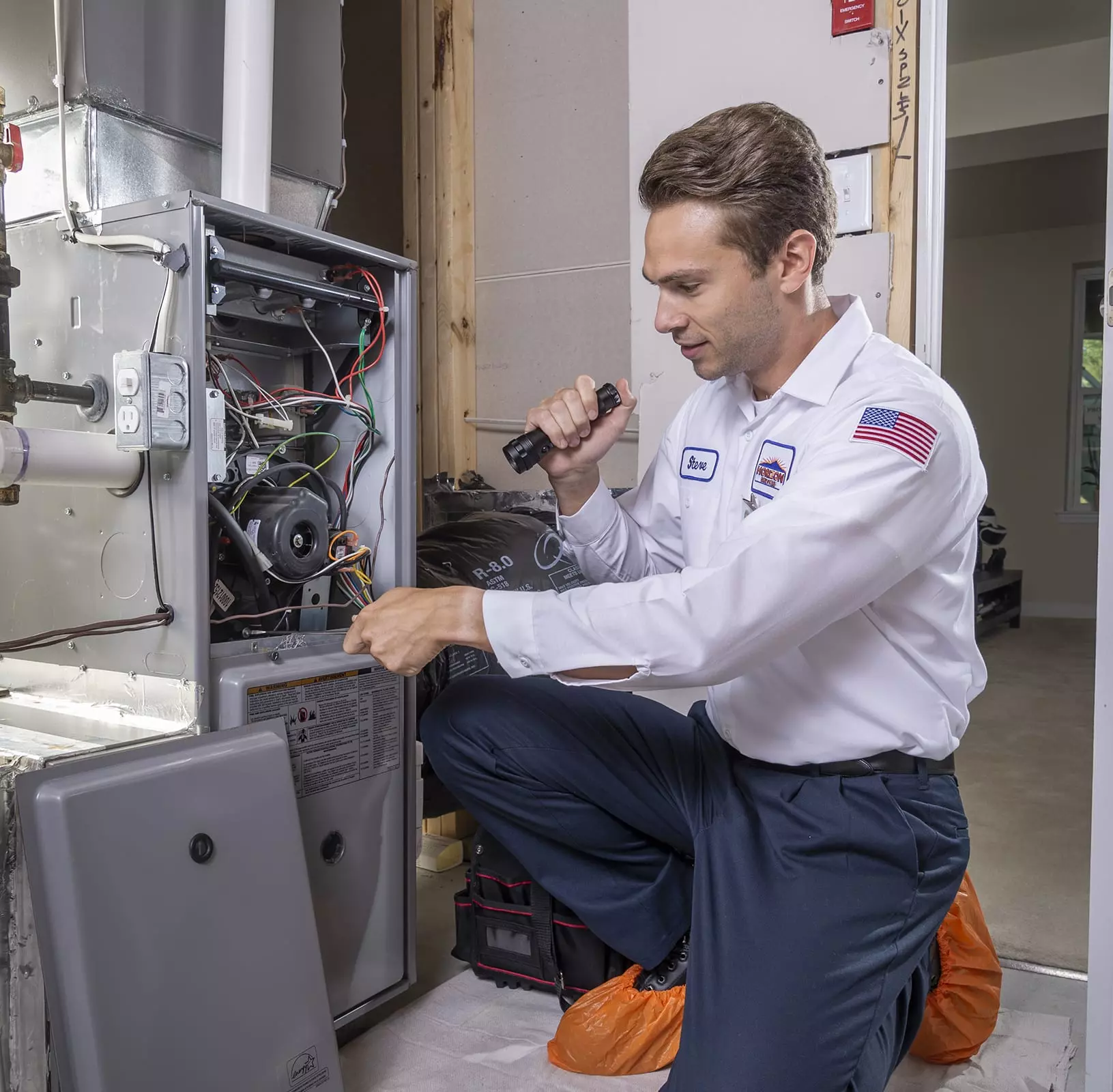 Horizon Services technician inspecting a home furnace